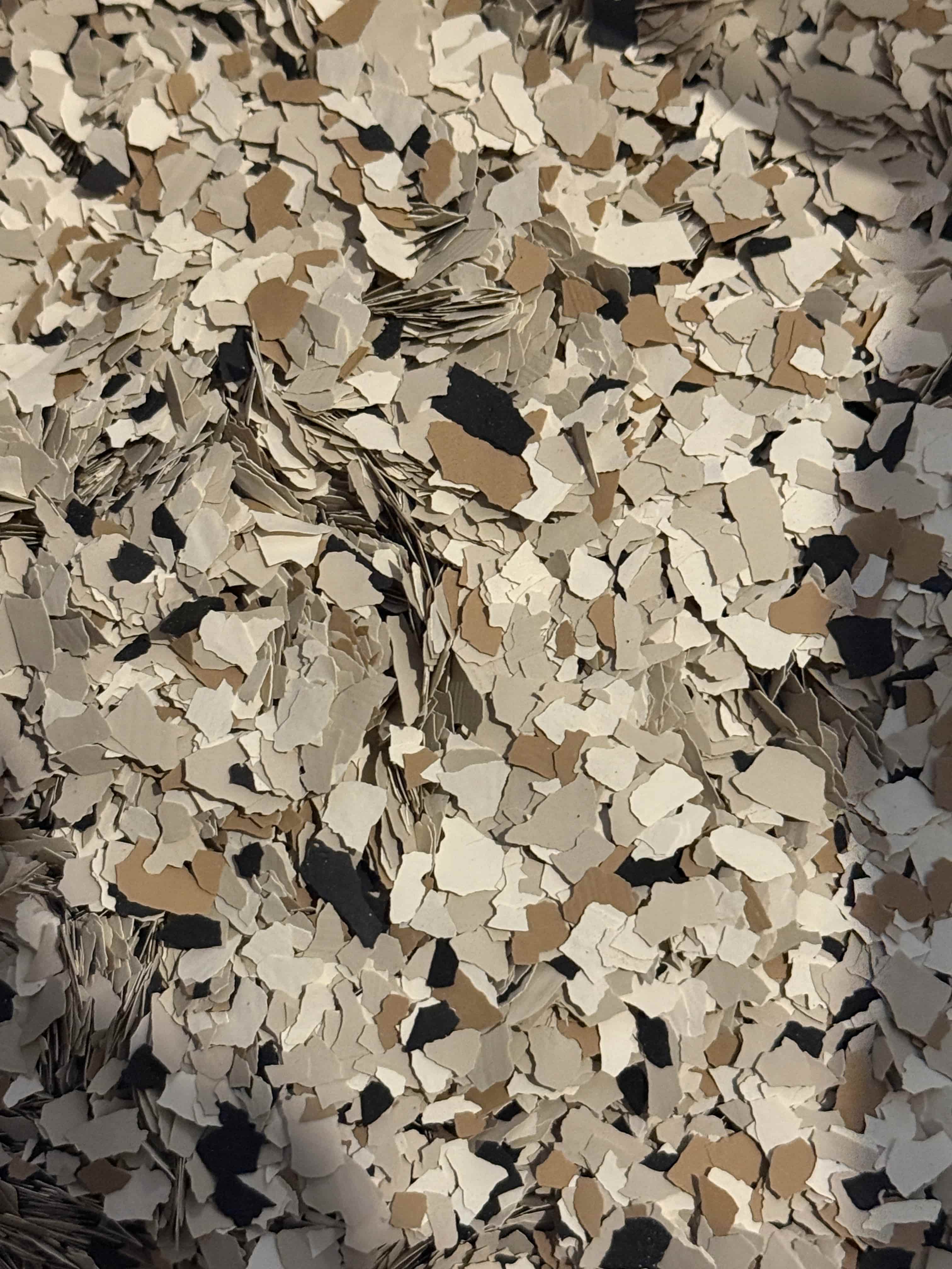 Decorative flakes being broadcast into wet epoxy