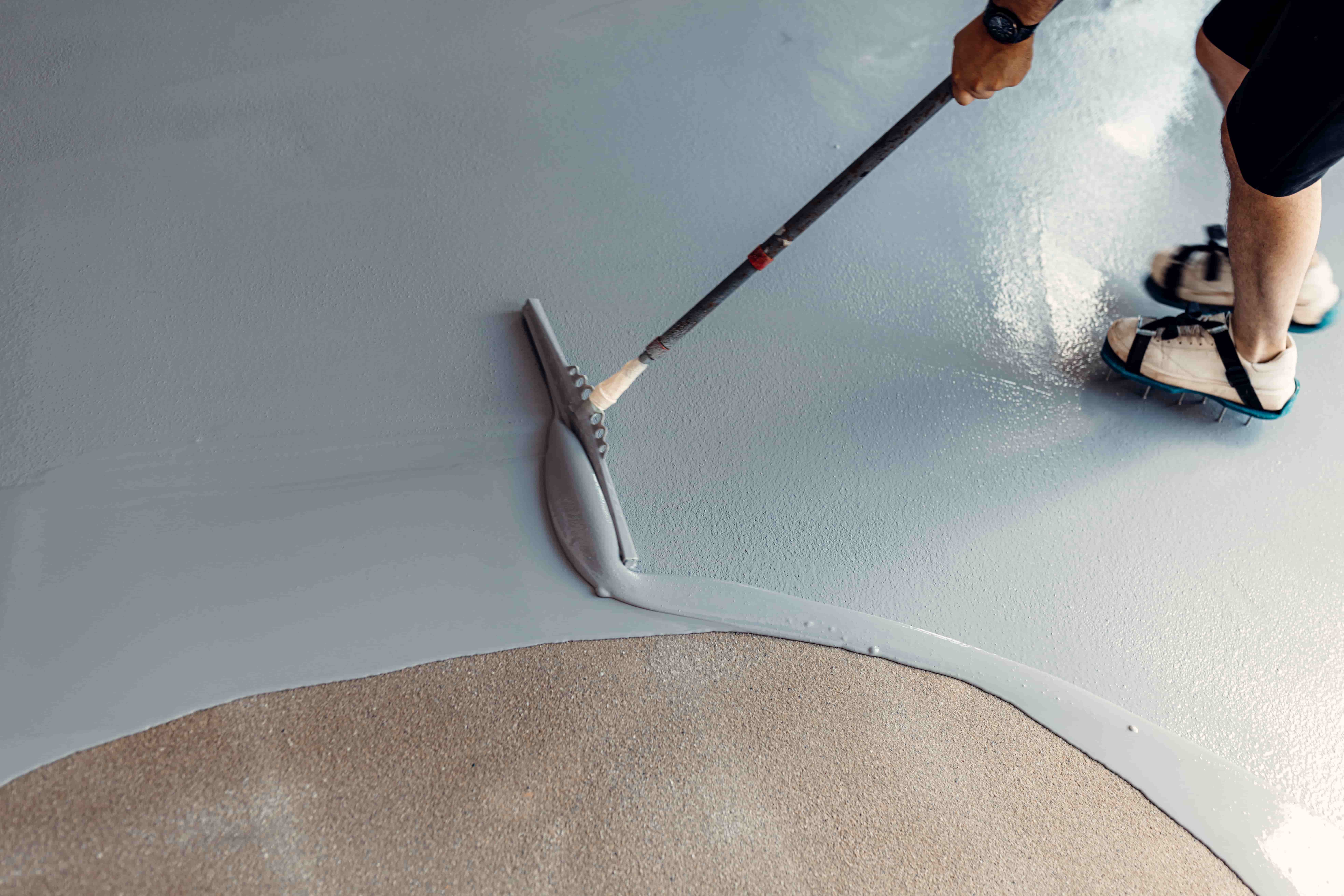 Industrial-grade epoxy base coat being applied